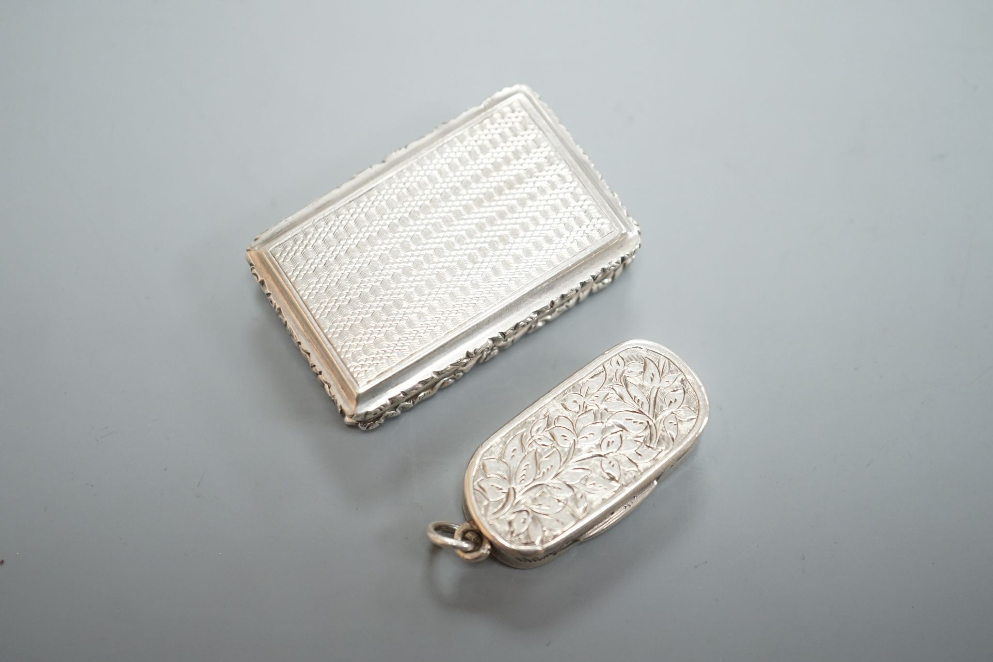 A William IV engraved silver rectangular vinaigrette, with engraved initials, Taylor & Perry, Birmingham, 1833, 42mm and a later oval vinaigrette, by George Unite.